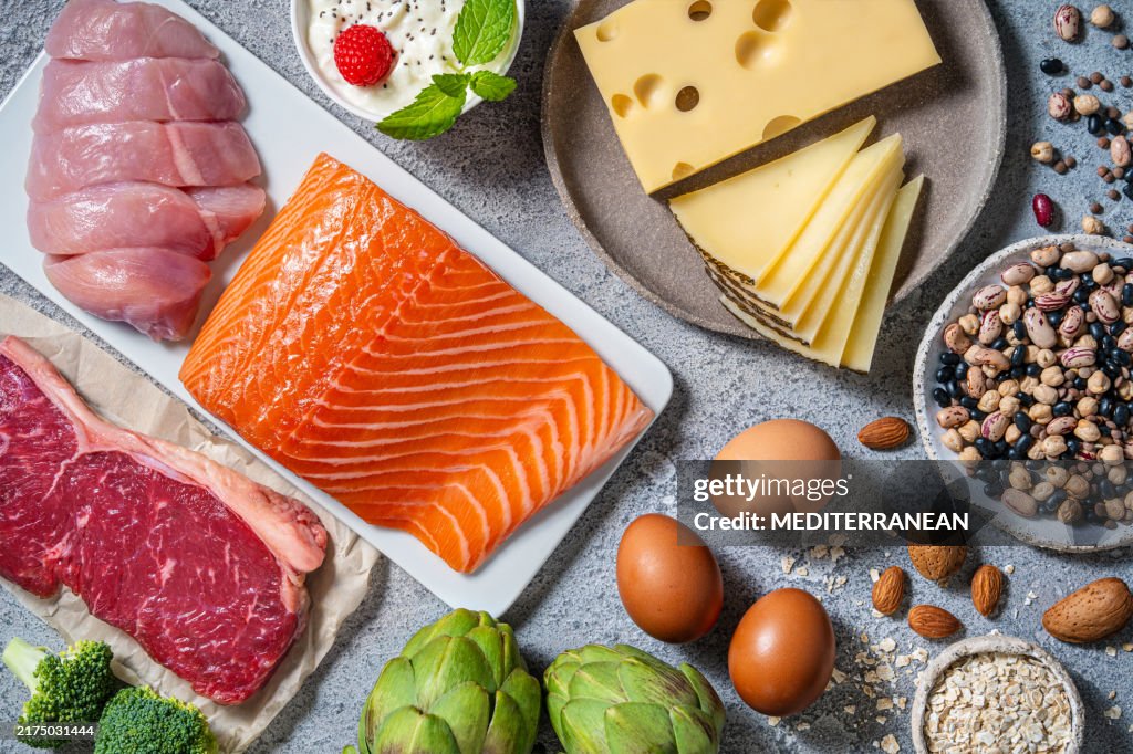 Assorted healthy protein source food good for body building: fish, meat, cheese, beans, eggs.