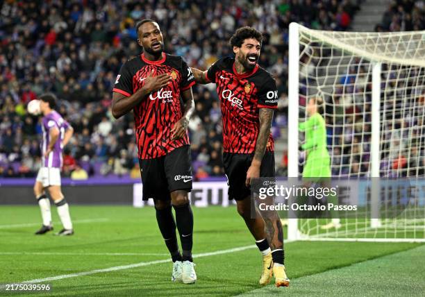 Cyle Larin of RCD Mallorca celebrates scoring his team's first goal with teammate Samu Costa during the LaLiga match between Real Valladolid CF and...