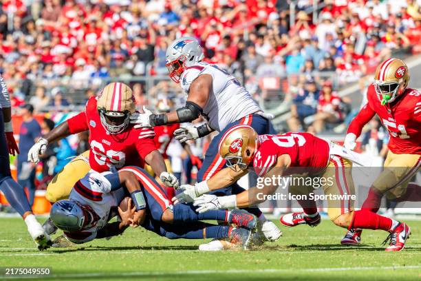 San Francisco 49ers defensive end Nick Bosa and San Francisco 49ers defensive tackle Evan Anderson tackle New England Patriots quarterback Jacoby...