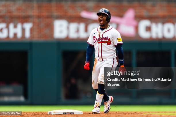 Ozzie Albies of Atlanta Braves celebrates after hitting an RBI double in the eighth inning during game one of a double header against the New York...