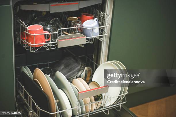 view of open dishwasher with kitchen utensils - dishwasher stock pictures, royalty-free photos & images
