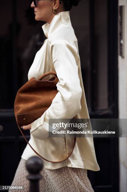 Gili Biegun wears silk shirt with neck details by Bevza, knitted maxi skirt by Herskind, brown suede bag by Elleme and shoes by Saint Laurent, Celine...
