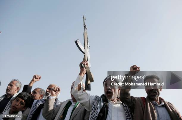 Houthi followers shout slogans as they take part in a protest staged against the Israeli aerial attacks on Lebanon, on September 27 in Sana'a, Yemen....