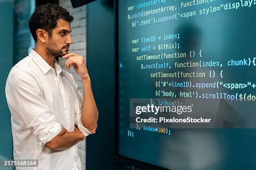 Professional software developer working late at night writing codes in an office. Professional software developer working late at night writing codes in an office.