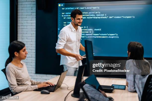 software developer team working together, discussing on coding on multi computer screen. - programming team stock pictures, royalty-free photos & images