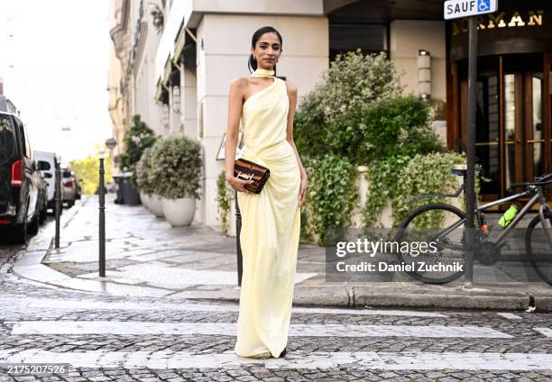 Malvika Sheth is seen wearing a Deme by Gabriella yellow dress and a brown and gold Tods bag outside the Nina Ricci show during Womenswear...