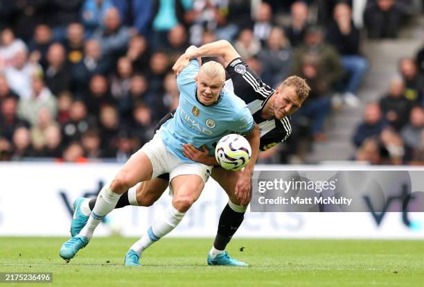Erling Haaland of Manchester City battles for possession with Dan Burn of Newcastle United during the Premier League match between Newcastle United...