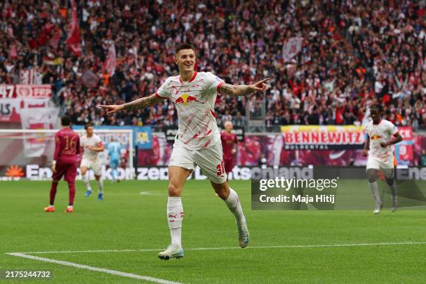 Benjamin Sesko of RB Leipzig celebrates scoring his team's first goal during the Bundesliga match between RB Leipzig and FC Augsburg at Red Bull...