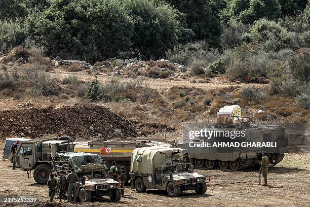 Israeli army vehicles deploy at a position along the border with Lebanon in northern Israel on October 1, 2024. The Israeli army on October 1 said it...