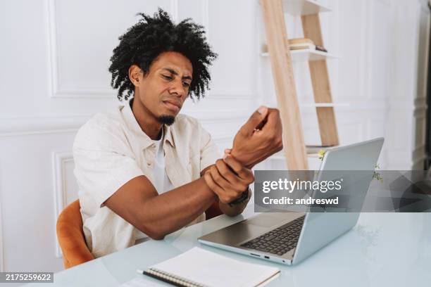 man with wrist pain - wrist stock pictures, royalty-free photos & images