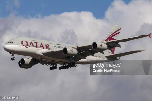 Qatar Airways Airbus A380 double decker passenger aircraft spotted flying in the air between the blue sky and the clouds, on final approach for...