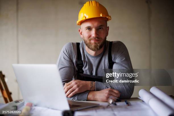 ritratto di un giovane fiducioso che lavora in cantiere - imprenditore edile foto e immagini stock