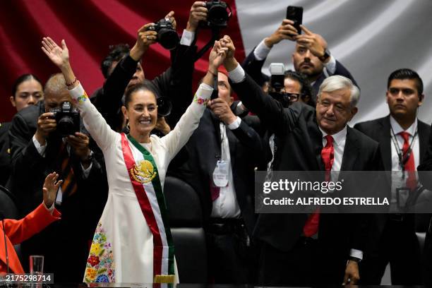 Mexico's new President Claudia Sheinbaum and outgoing Mexican President Andres Manuel Lopez Obrador wave to the attendees during the inauguration...