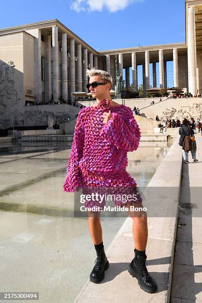 Ash Dimoni Ash Dimoni is wearing black sunglasses, a pink sweater, pink pants ...