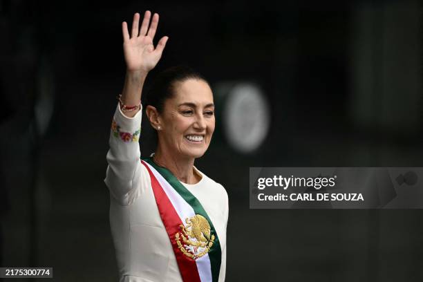 Mexico's President Claudia Sheinbaum waves at the crowd as she leaves the Congress of the Union after her inauguration ceremony in Mexico City on...
