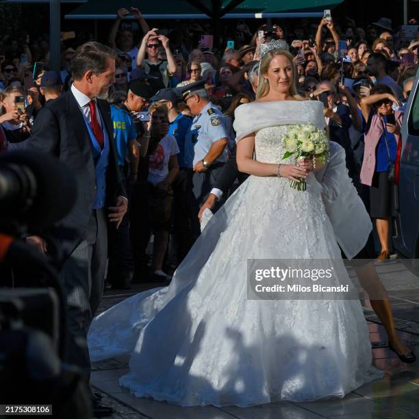 Theodora of Greece arrives on the arm of her brother Paul to marry Matthew Kumar at the Metropolis Greek Orthodox Cathedral on September 28, 2024 in...