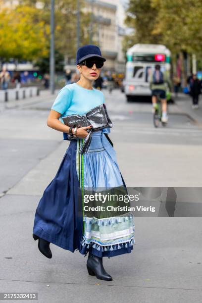 Salome Chaboki wears Dirndl look skirt and top Michaela Keune, cowboy boots Sheme, navy hat a cuckoo moment, sunglasses Chanel, silver bag a cuckoo...