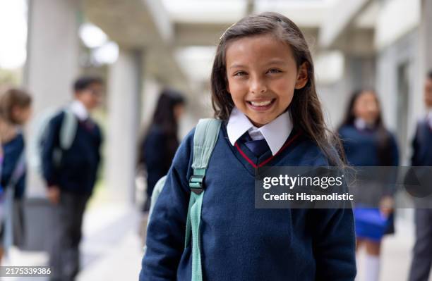 fille heureuse souriant dans le couloir de l’école - uniforme photos et images de collection
