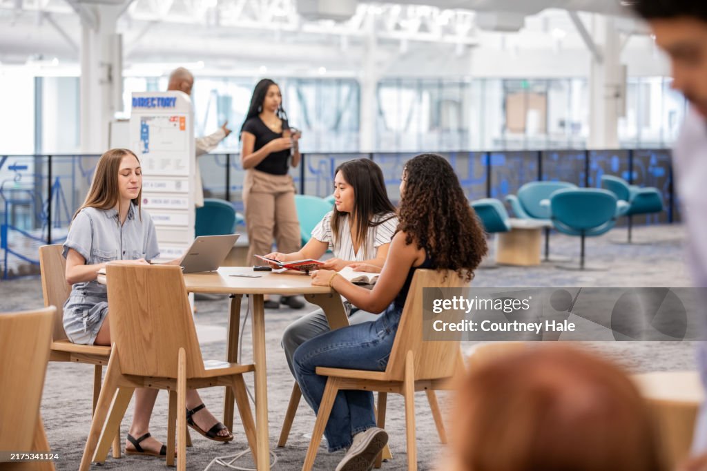 Diverse groups of people gather in community space at public library