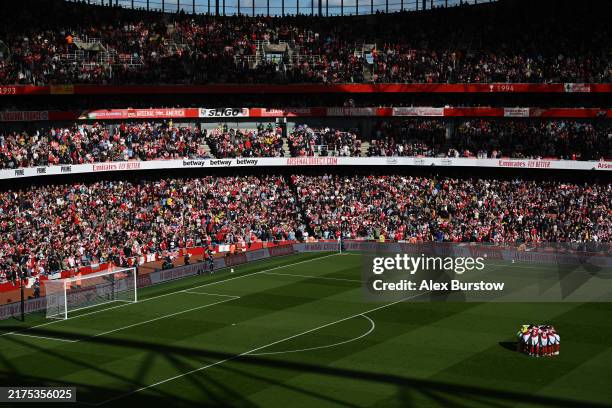General view inside the stadium as the Arsenal team form a huddle prior to the Premier League match between Arsenal FC and Leicester City FC at...