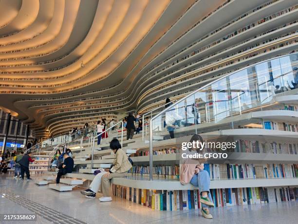 Readers read at the library of Binhai New Area in North China's Tianjin municipality, Oct 2, 2024.