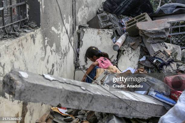 Palestinians are among the buildings which were destroyed by an Israeli strike, which caused the death of at least 40 people according to the...