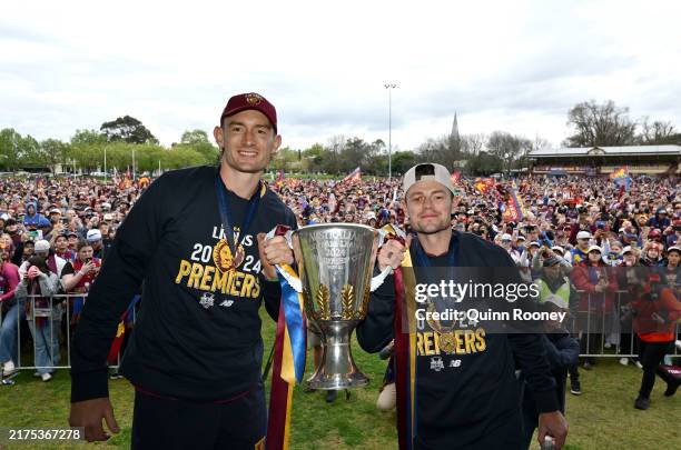 Harris Andrews and Lachie Neale of the Lions pose with the Premiership Cup after winning the 2024 AFL Grand Final at Brunswick Street Oval, on...
