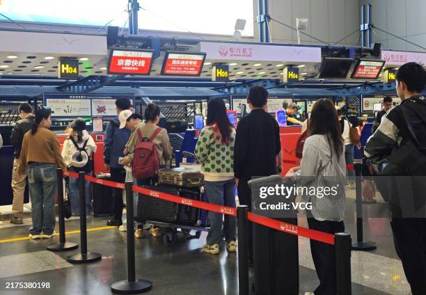 Travelers crowd at Beijing Capital International Airport ahead of the National Day holiday on September 29, 2024 in Beijing, China.