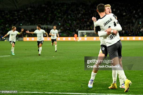 Marin Jakolis of Macarthur FC is congratulated by Jed Drew after scoring a goal during the 2024 Australia Cup Final match between Melbourne Victory...