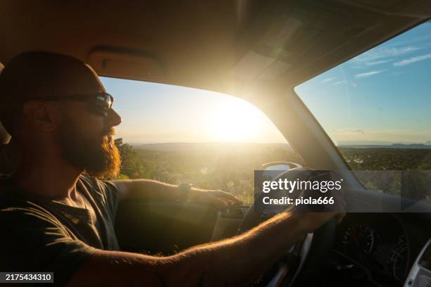 man driving a car on american highway - car interior stock pictures, royalty-free photos & images