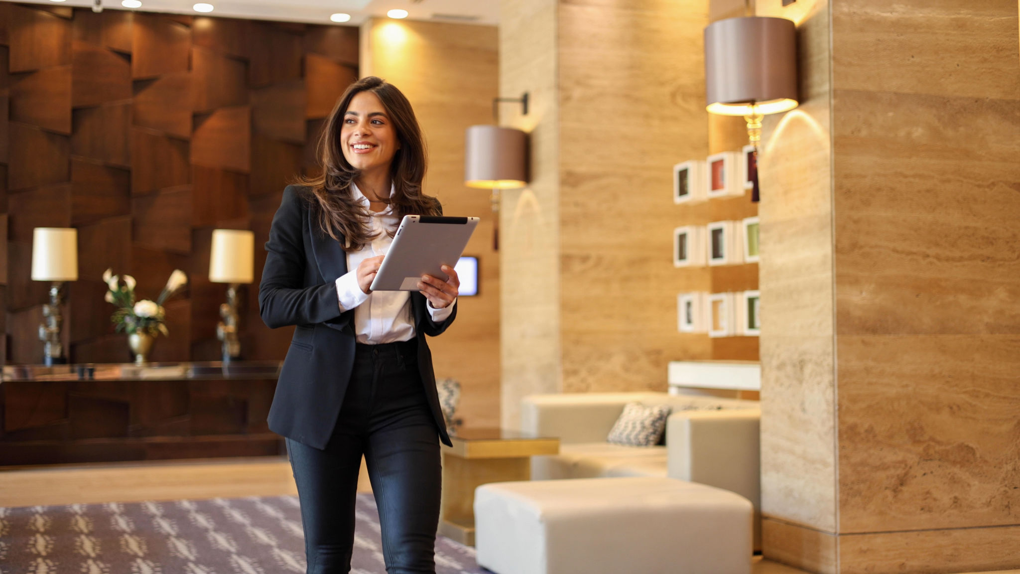 Confident businesswoman using tablet at the company lobby Confident businesswoman using tablet at the company lobby