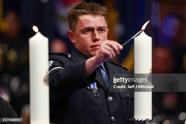 Luke Ratana lights a candle in memory of his father Sergeant Matt Ratana who was shot by a prisoner in Croydon Custody Centre in 2020, during the...