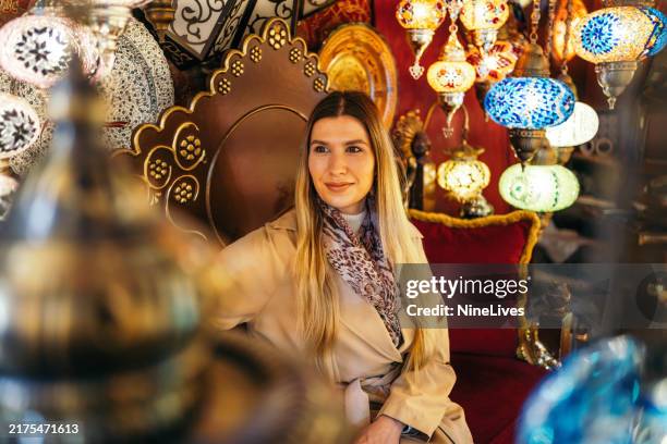 woman in a lamp shop in the grand bazaar in istanbul - middle eastern lanterns stock pictures, royalty-free photos & images