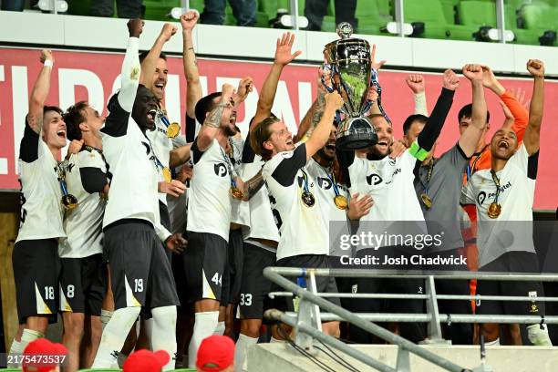 Macarthur FC hold the trophy aloft after winning the 2024 Australia Cup Final match between Melbourne Victory and Macarthur FC at AAMI Park on...