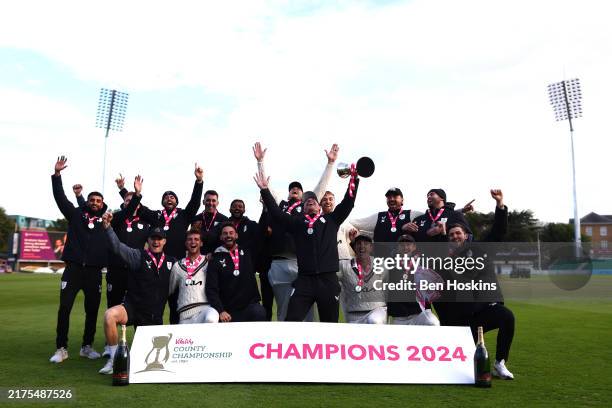 Rory Burns of Surrey lifts the trophy following during day four of the Vitality County Championship match between Essex and Surrey at The Cloud...