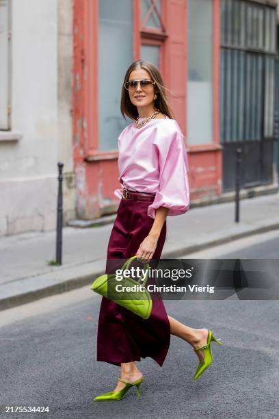 Nina Sandbech wears burgundy skirt and pink top homemade, green heels Prada, green bag Mietis, sunglasses Loewe during Womenswear Spring/Summer 2025...