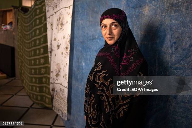 Year-old Hoda Zaher poses for the camera in the room of a Beirut school where she lives as a refugee after having to flee with her family from Dahiye...