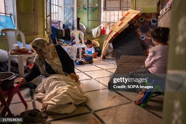 Boy plays in a classroom of a school taken over by Lebanese refugees for shelter after being forced to flee the south of the country and the suburbs...