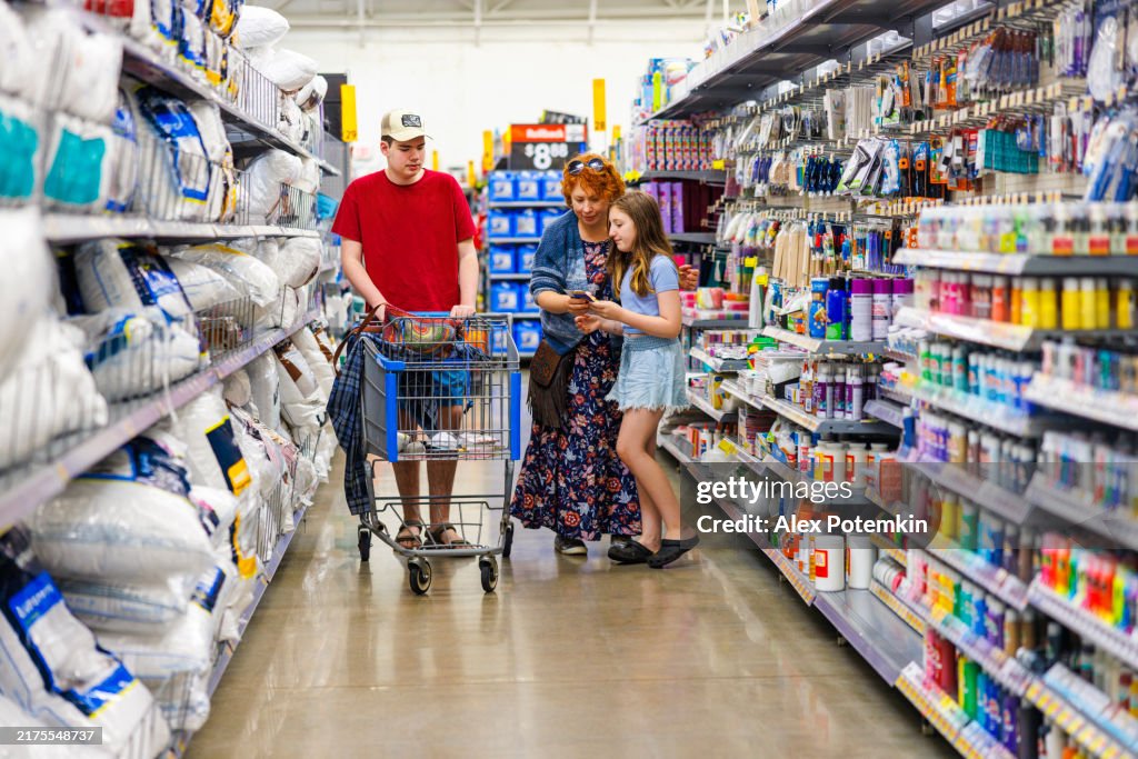 Family supports autistic teenager during supermarket trip.