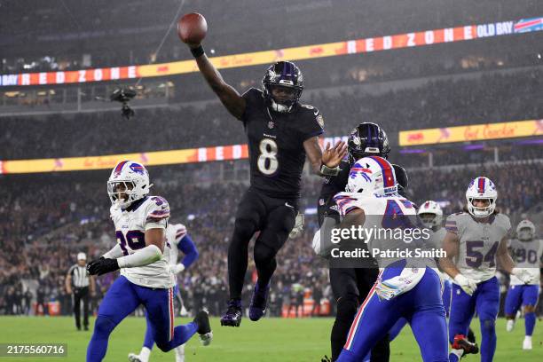 Lamar Jackson of the Baltimore Ravens scores a touchdown during the third quarter against the Buffalo Bills at M&T Bank Stadium on September 29, 2024...
