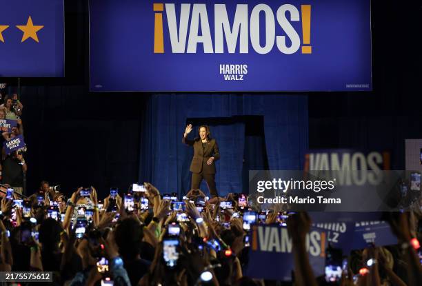 Democratic presidential nominee, Vice President Kamala Harris, walks onstage with campaign signs reading 'Vamos!' , during a campaign rally at the...