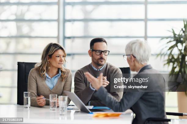 couple talking to their agent on a meeting in the office. - life insurance stock pictures, royalty-free photos & images