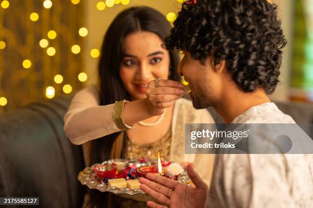 siblings celebrating raksha bandhan festival - raksha bandhan stock pictures, royalty-free photos & images