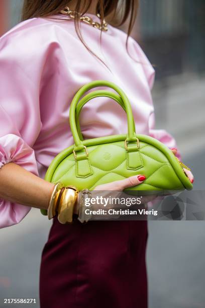 Nina Sandbech wears burgundy skirt and pink top homemade, green heels Prada, green bag Mietis during Womenswear Spring/Summer 2025 as part of Paris...
