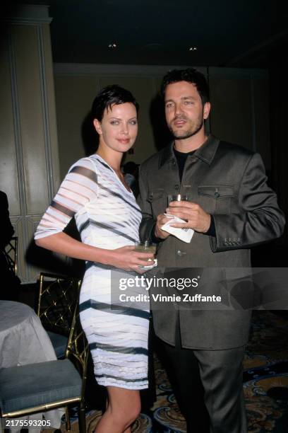 South African and American actress Charlize Theron with American singer Stephan Jenkins at the 46th Annual BMI Pop Awards in Beverly Hills, May 1998.