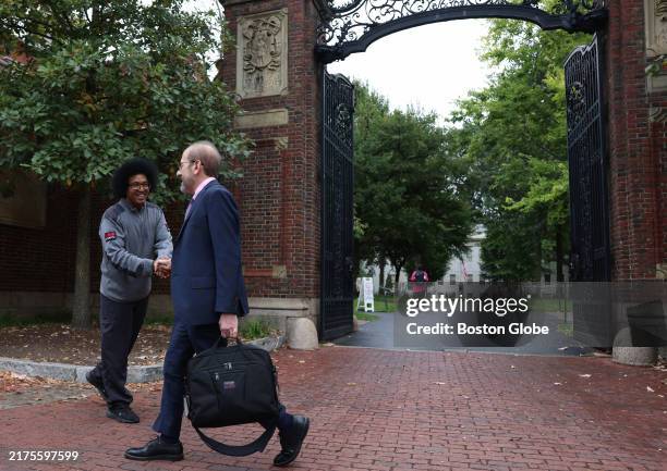 Cambridge, MA Harvard University President Alan M. Garber shook hands with a security guard as he walked past Johnston Gate.