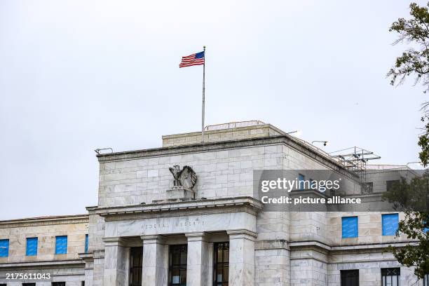 October 2024, USA, Washington: The US flag flies over the Federal Reserve. Photo: Valerie Plesch/dpa