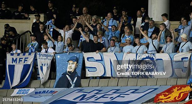 Malmoe fans shout prior to the UEFA Europa League football match between Qarabag FK and Malmoe FF at the Tofiq Bahramov Republican Stadium in Baku,...