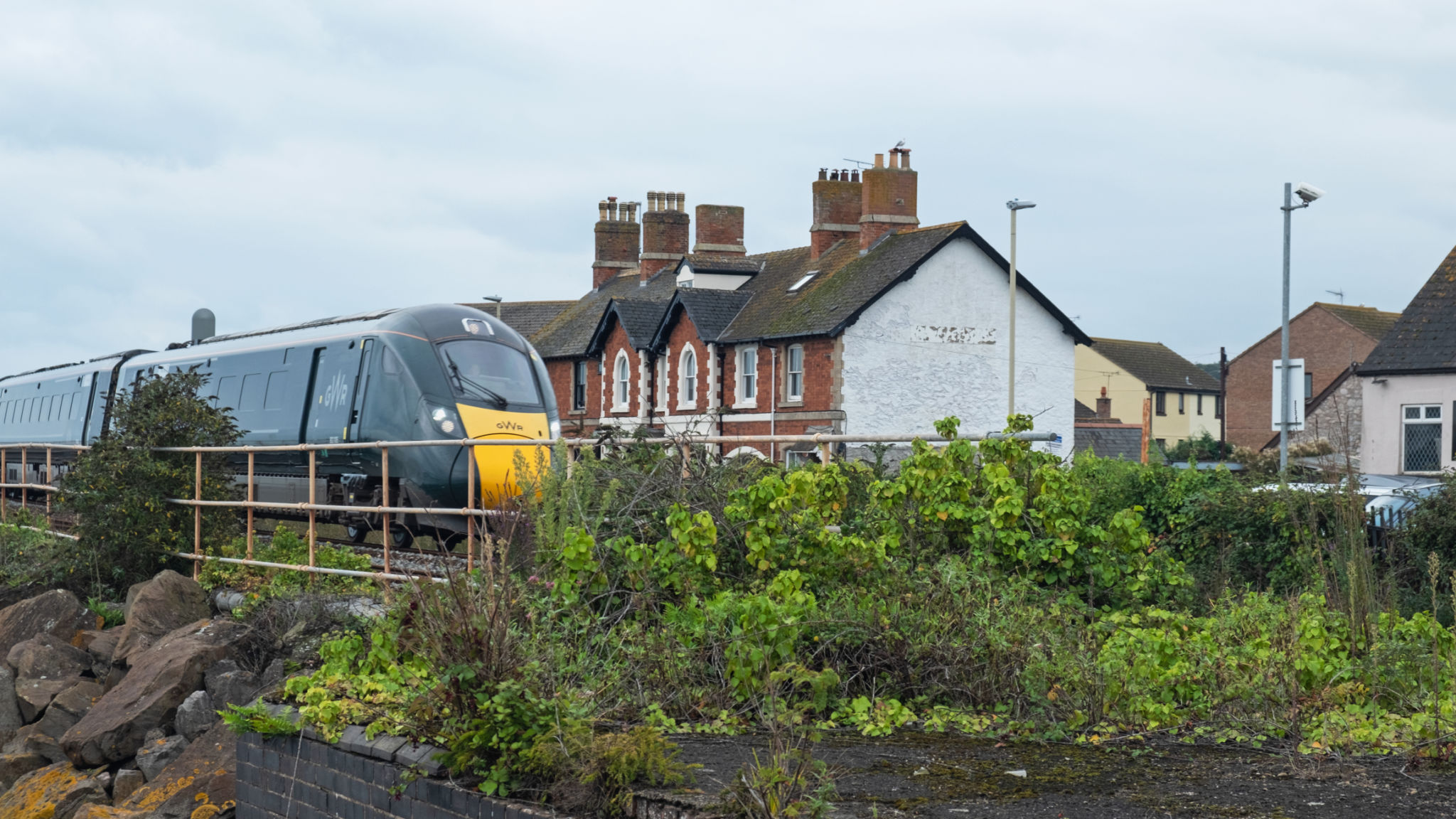 GWR express passing through a Devon village at speed UK GWR express passing through a Devon village at speed UK