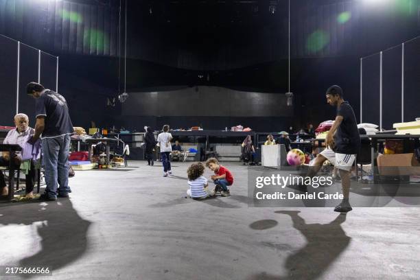 Internally displaced people socialize at a discotheque converted into an IDP shelter on October 3, 2024 in Beirut, Lebanon. Israel continued...